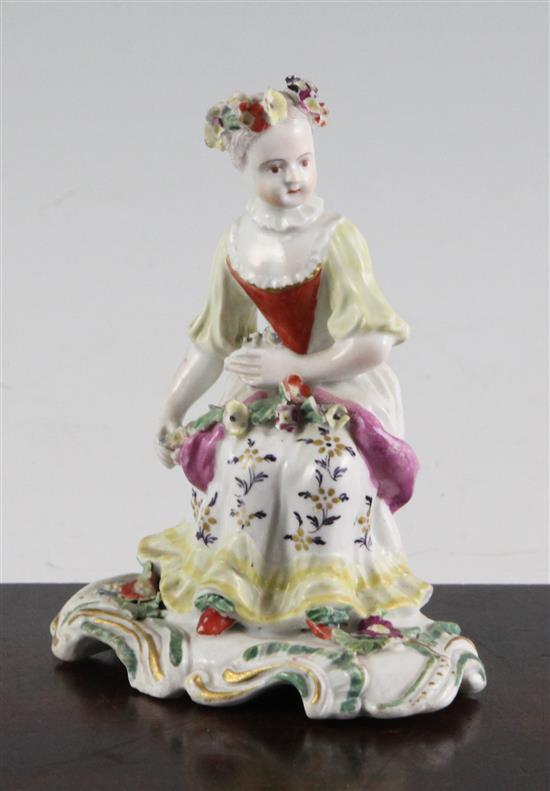 A Derby Pale Family figure of a seated lady, c.1756-9, height 11cm, tiny losses